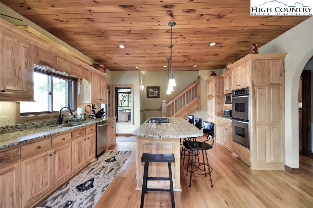 86 Tyneridge Road Banner Elk, NC 28604 - Photo 15 of 50 a large kitchen with stainless steel appliances granite countertop a stove and a wooden floors