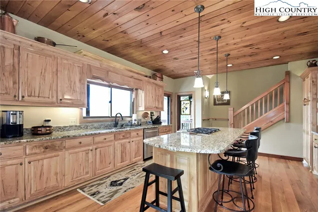 a kitchen with granite countertop cabinets and window