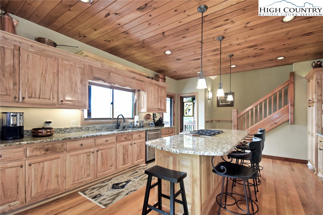 86 Tyneridge Road Banner Elk, NC 28604 - Photo 16 of 50 a kitchen with granite countertop sink cabinets and wooden floor