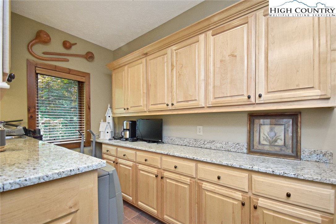 86 Tyneridge Road Banner Elk, NC 28604 - Photo 18 of 50 a kitchen with granite countertop cabinets and window