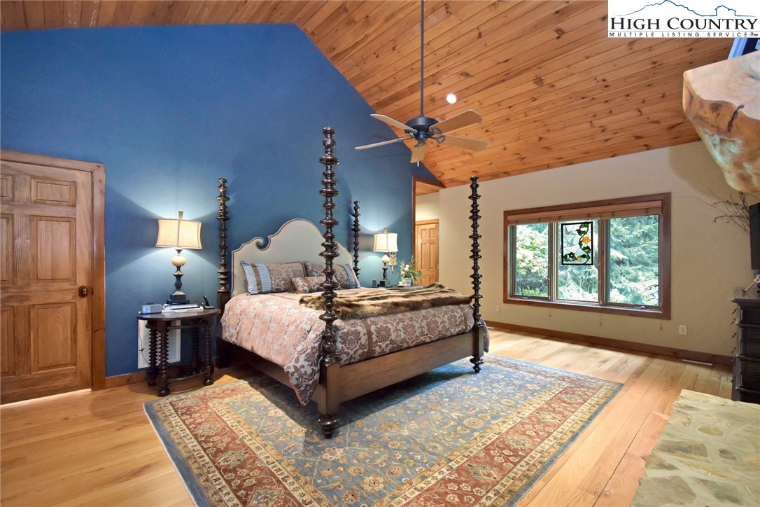86 Tyneridge Road Banner Elk, NC 28604 - Photo 22 of 50 a spacious bedroom with a bed lamp closet and large window