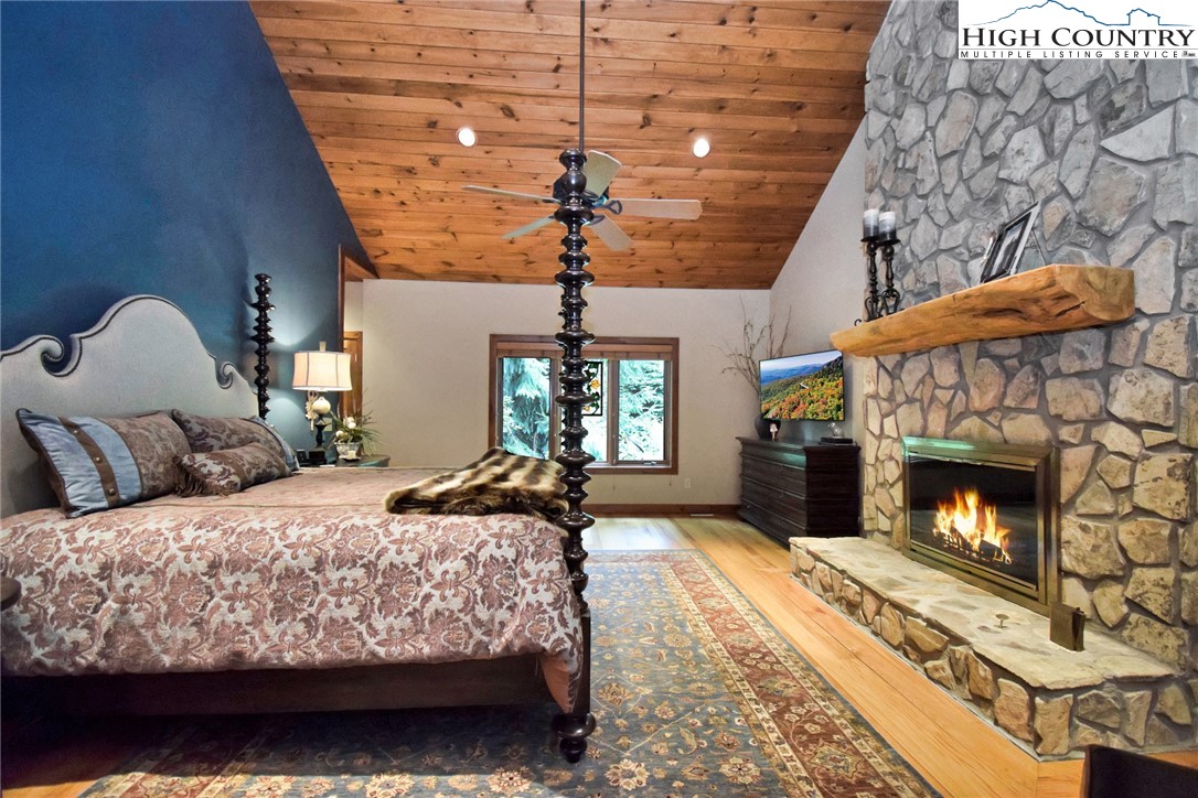 86 Tyneridge Road Banner Elk, NC 28604 - Photo 23 of 50 a bedroom with a bed and a fireplace