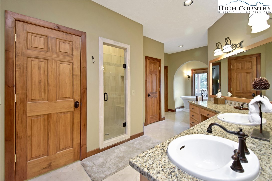 86 Tyneridge Road Banner Elk, NC 28604 - Photo 25 of 50 a en suite bathroom with a sink and a mirror