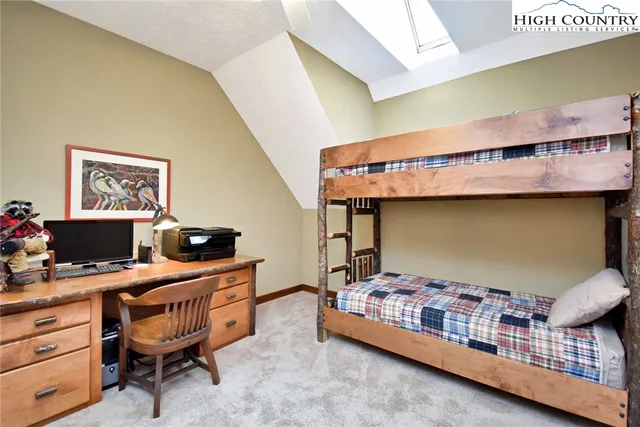 a living room with furniture a rug and a chandelier