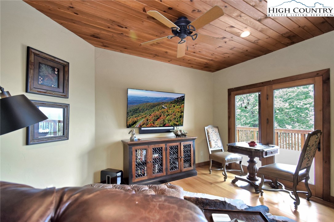 86 Tyneridge Road Banner Elk, NC 28604 - Photo 6 of 50 a living room with furniture a flat screen tv and a large window