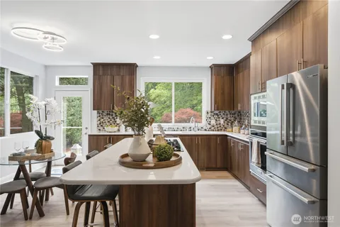 a kitchen with a table chairs refrigerator and microwave