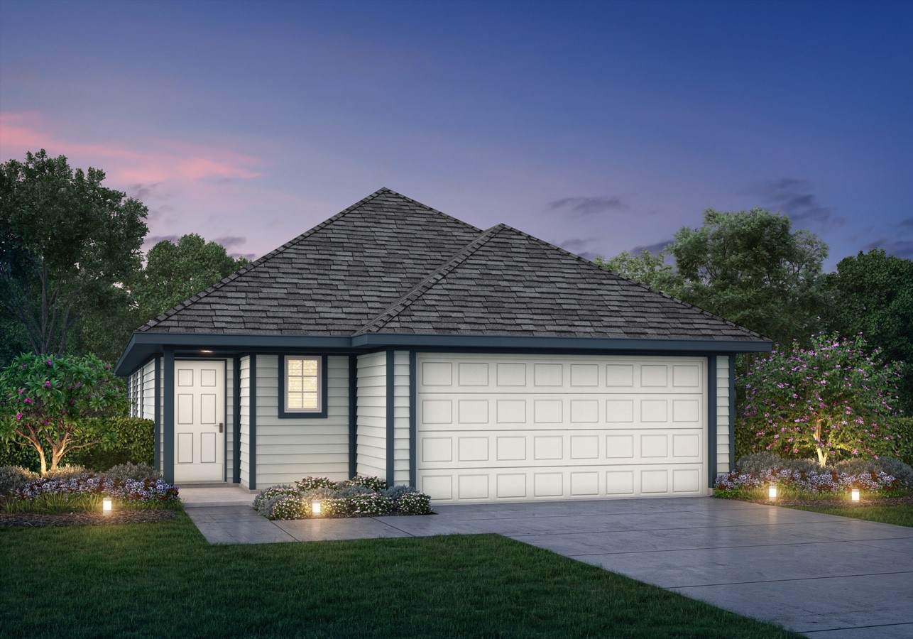 a front view of a house with a garden and yard