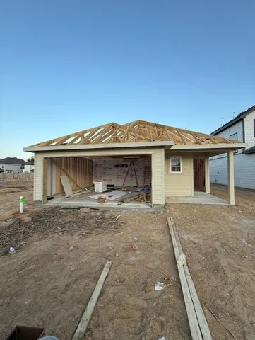 a view of a house with a wooden fence