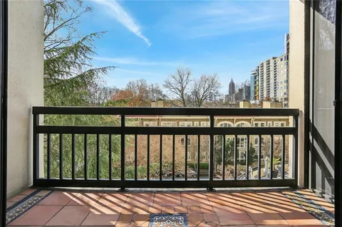 a view of a balcony with wooden fence