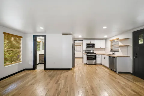 a kitchen with a refrigerator and a stove top oven