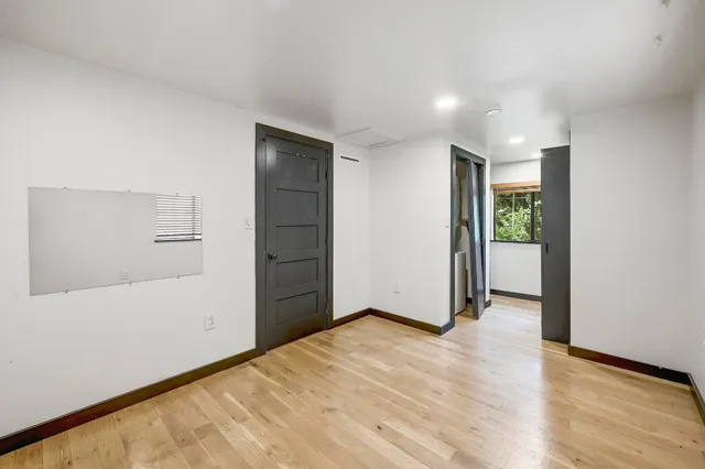 an empty room with closet and wooden floor