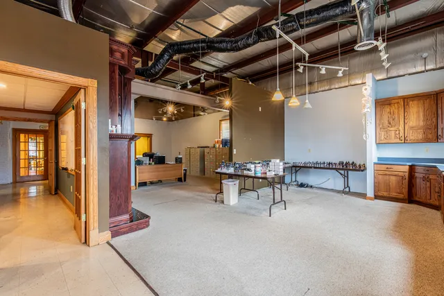 a view of a hallway with a chair and a chandelier