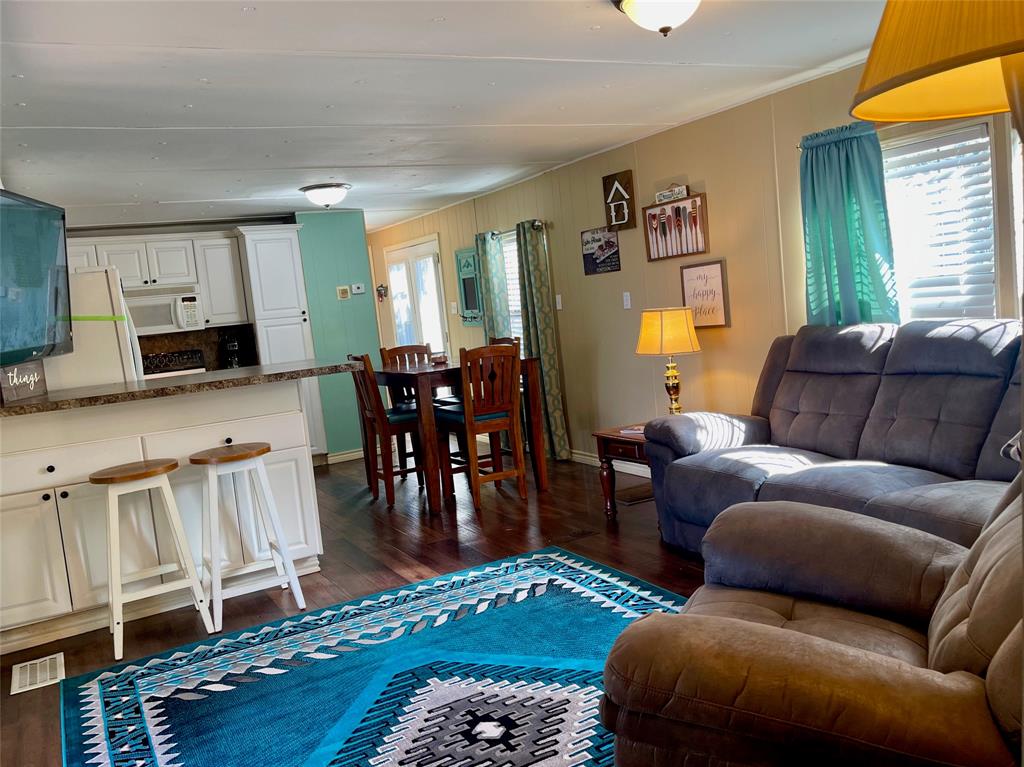 2334 San Bar Road, Unit 50 Graford, TX 76449 - Photo 15 of 40 Living room, dining space, kitchen, hallway with laundry leads to the master suite and french doors lead outside to the back deck.