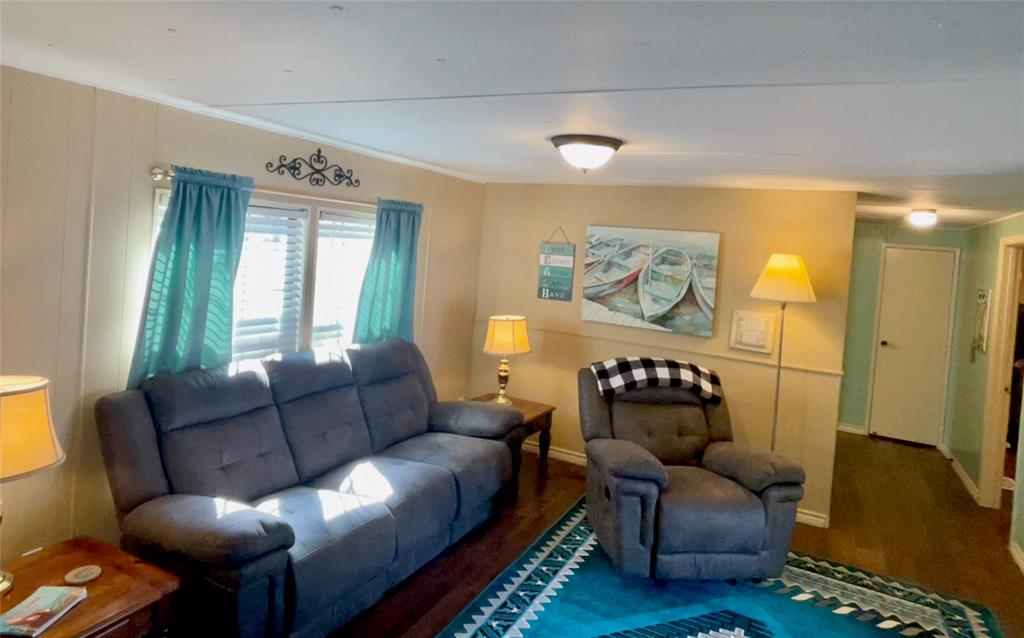 2334 San Bar Road, Unit 50 Graford, TX 76449 - Photo 16 of 40 Spacious living room with lots of natural light; hallway to two guest rooms and bath.