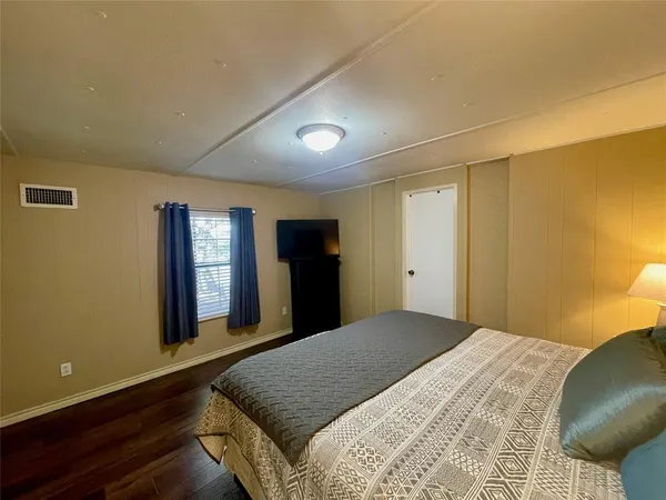 a bedroom with a bed and window