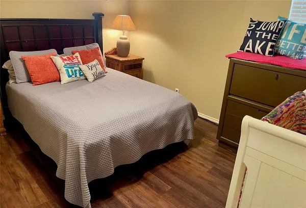 a bedroom with a bed and a night stand