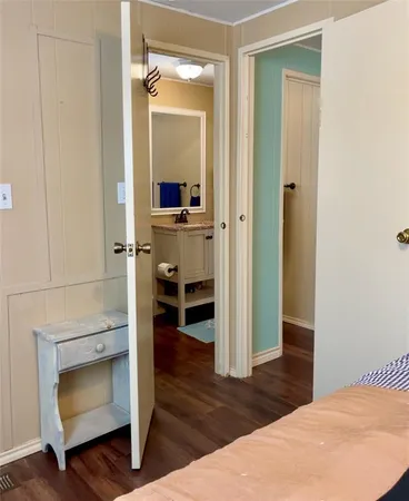 a bedroom with a bed and a mirror