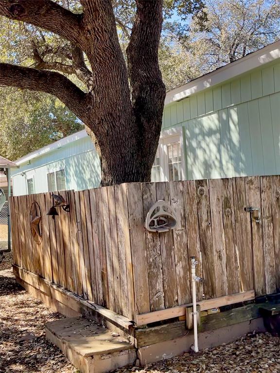 2334 San Bar Road, Unit 50 Graford, TX 76449 - Photo 34 of 40 Wood fencing and deck built around this awesome tree that provides a shady space for grilling or relaxing; french doors allow easy entry into the home.