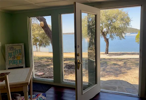 a view of a room with wooden floor and front door