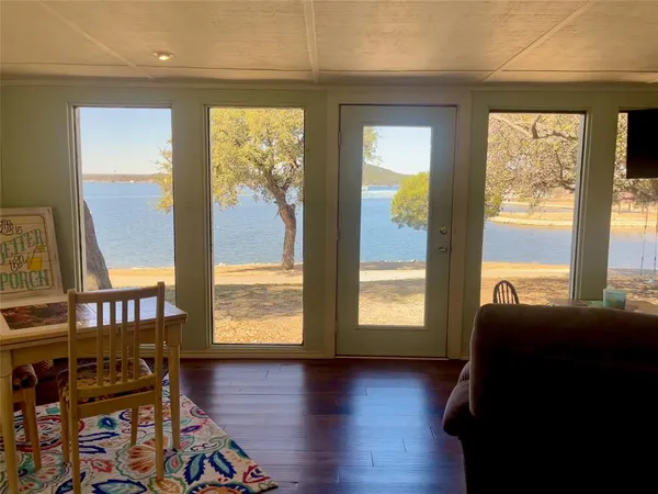a view of room with windows and wooden floor