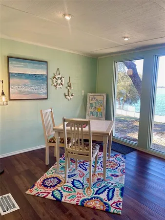 a living room with furniture a rug and a floor to ceiling window