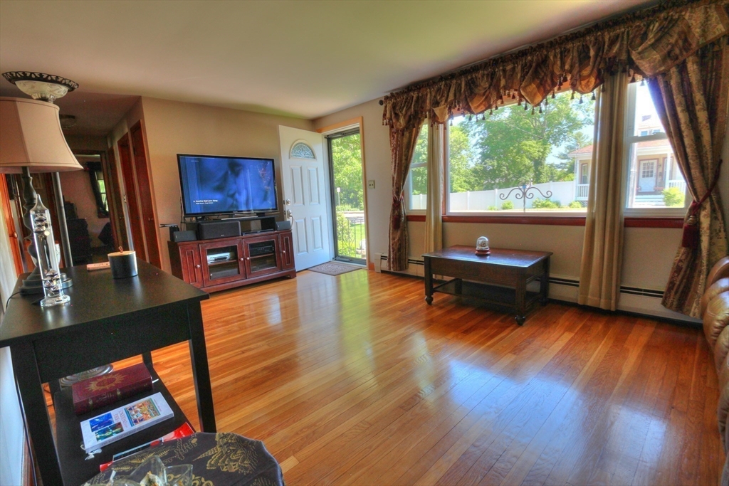 289 Winter Street Brockton, MA 02302 - Photo 12 of 27 a living room with furniture a fireplace and a flat screen tv