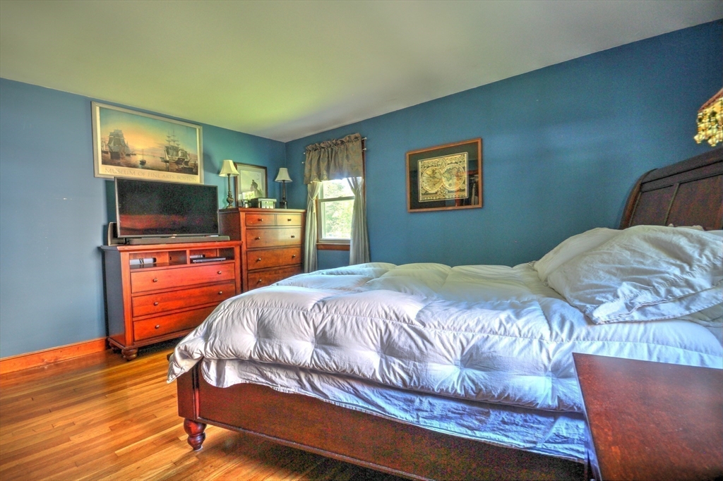 289 Winter Street Brockton, MA 02302 - Photo 14 of 27 a bedroom with a bed and a flat screen tv