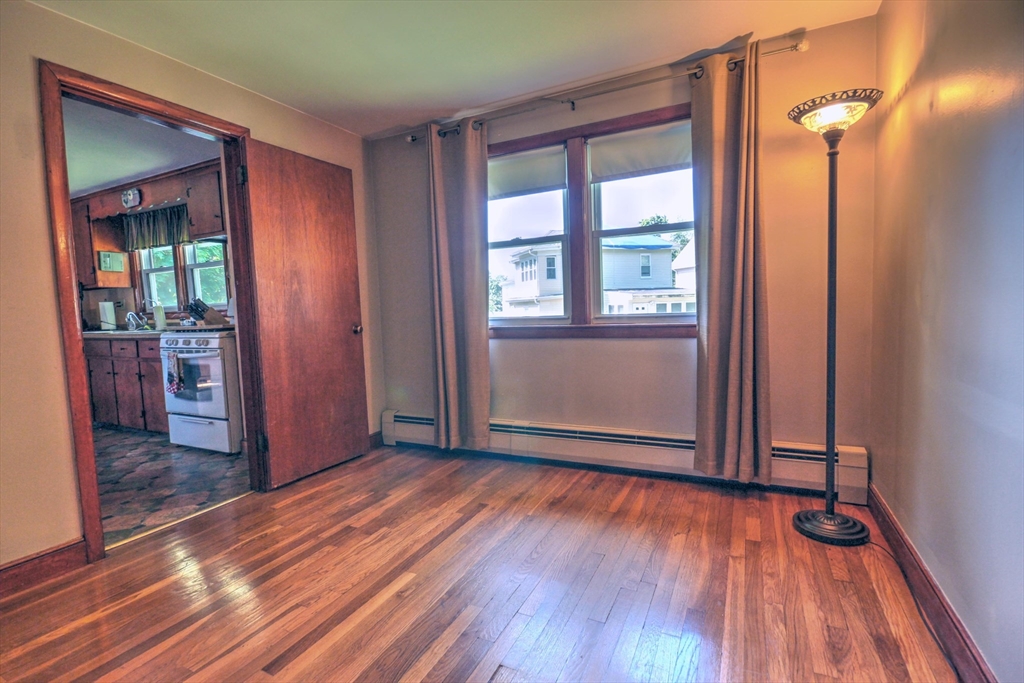 289 Winter Street Brockton, MA 02302 - Photo 18 of 27 wooden floor in an empty room with a window