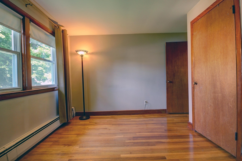 289 Winter Street Brockton, MA 02302 - Photo 19 of 27 a view of an empty room with wooden floor and a window