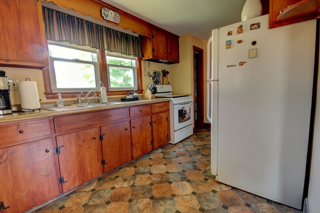 289 Winter Street Brockton, MA 02302 - Photo 7 of 27 a kitchen with stainless steel appliances a refrigerator sink and wooden cabinets