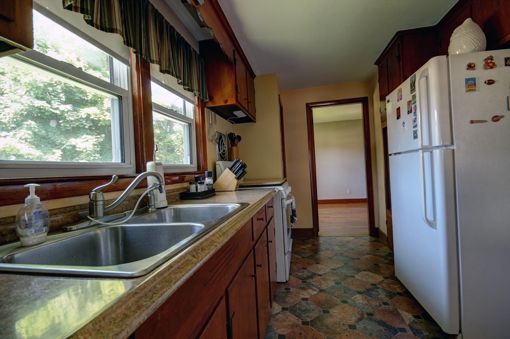 289 Winter Street Brockton, MA 02302 - Photo 8 of 27 a kitchen with a sink and a refrigerator