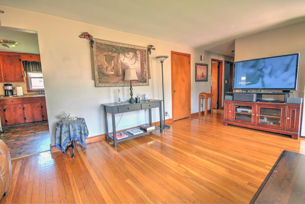 289 Winter Street Brockton, MA 02302 - Photo 10 of 27 a living room with furniture a wooden floor and a flat screen tv