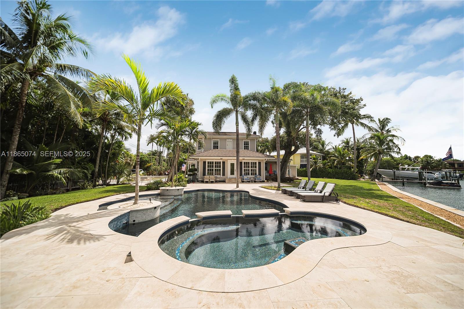 1020 Lands End Way Jupiter, FL 33458 - Photo 12 of 79 a view of a swimming pool with outdoor seating and plants
