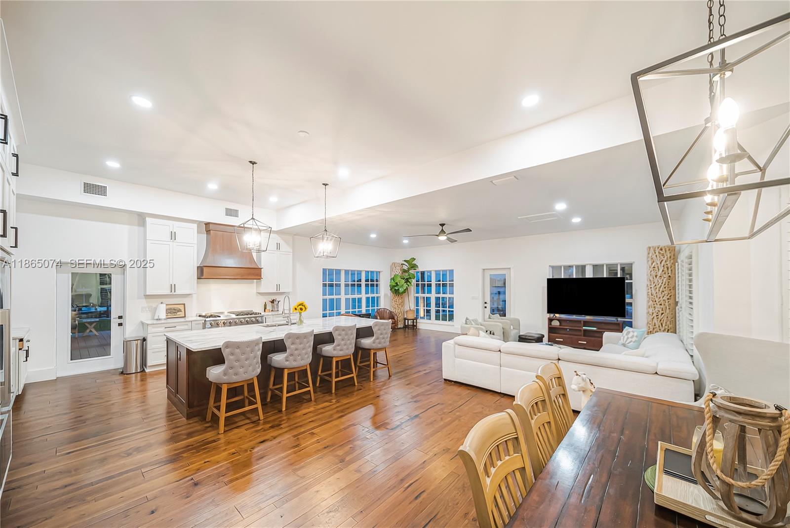 1020 Lands End Way Jupiter, FL 33458 - Photo 17 of 79 a view of a dining room with furniture wooden floor and a chandelier