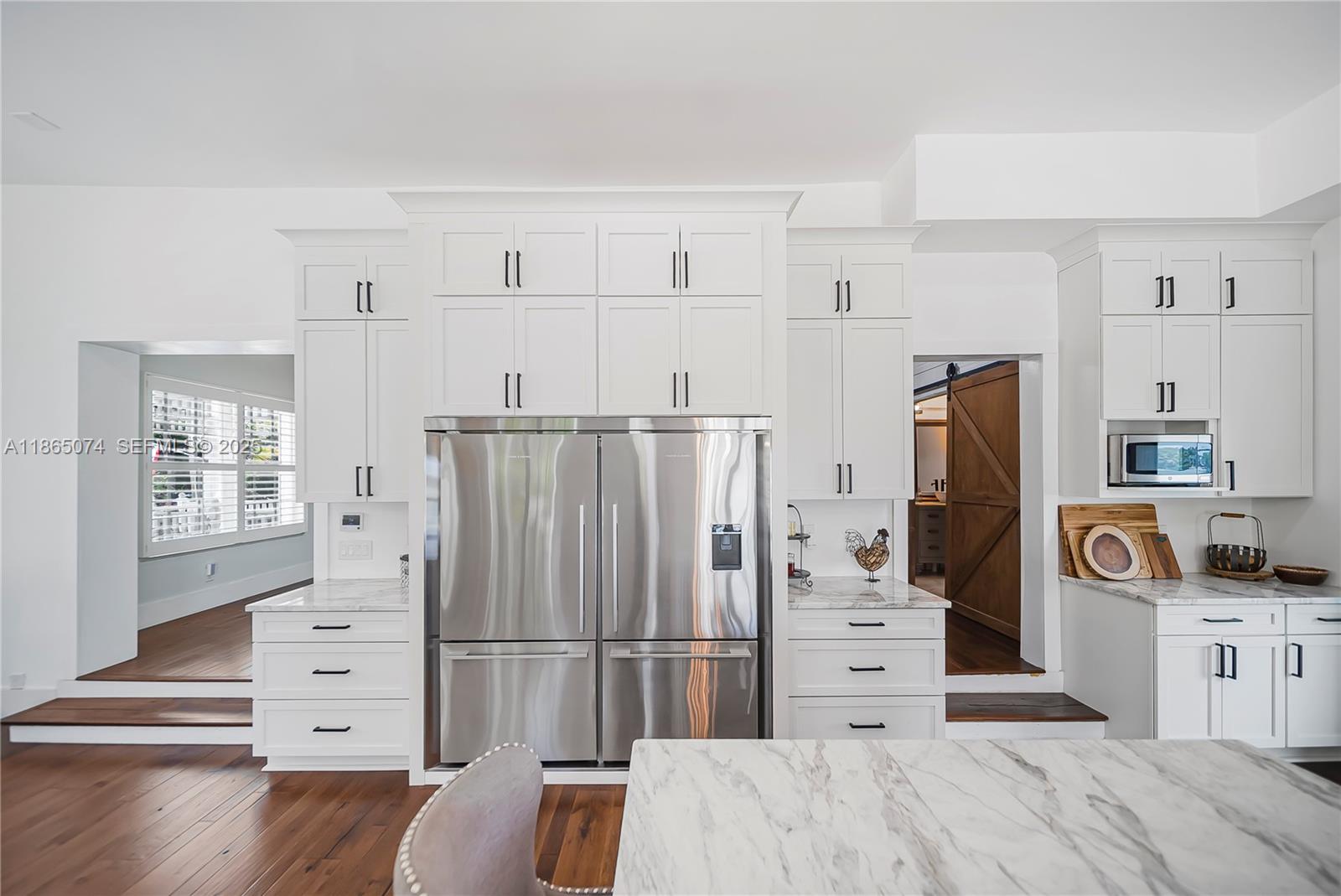 1020 Lands End Way Jupiter, FL 33458 - Photo 23 of 79 a kitchen with stainless steel appliances a refrigerator and cabinets