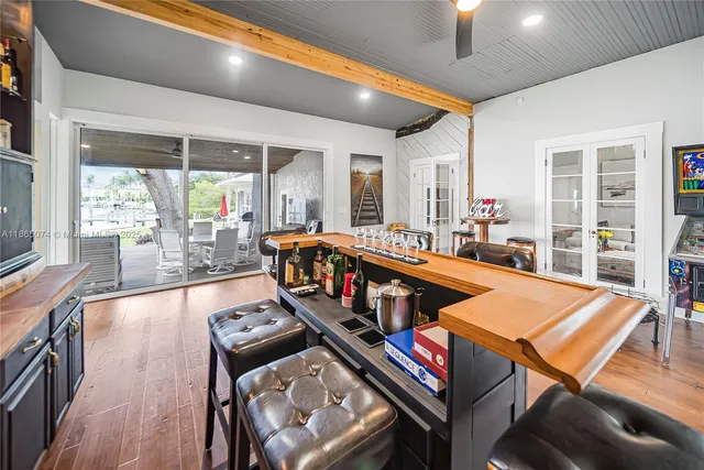 an aerial view of ocean and residential houses with outdoor space