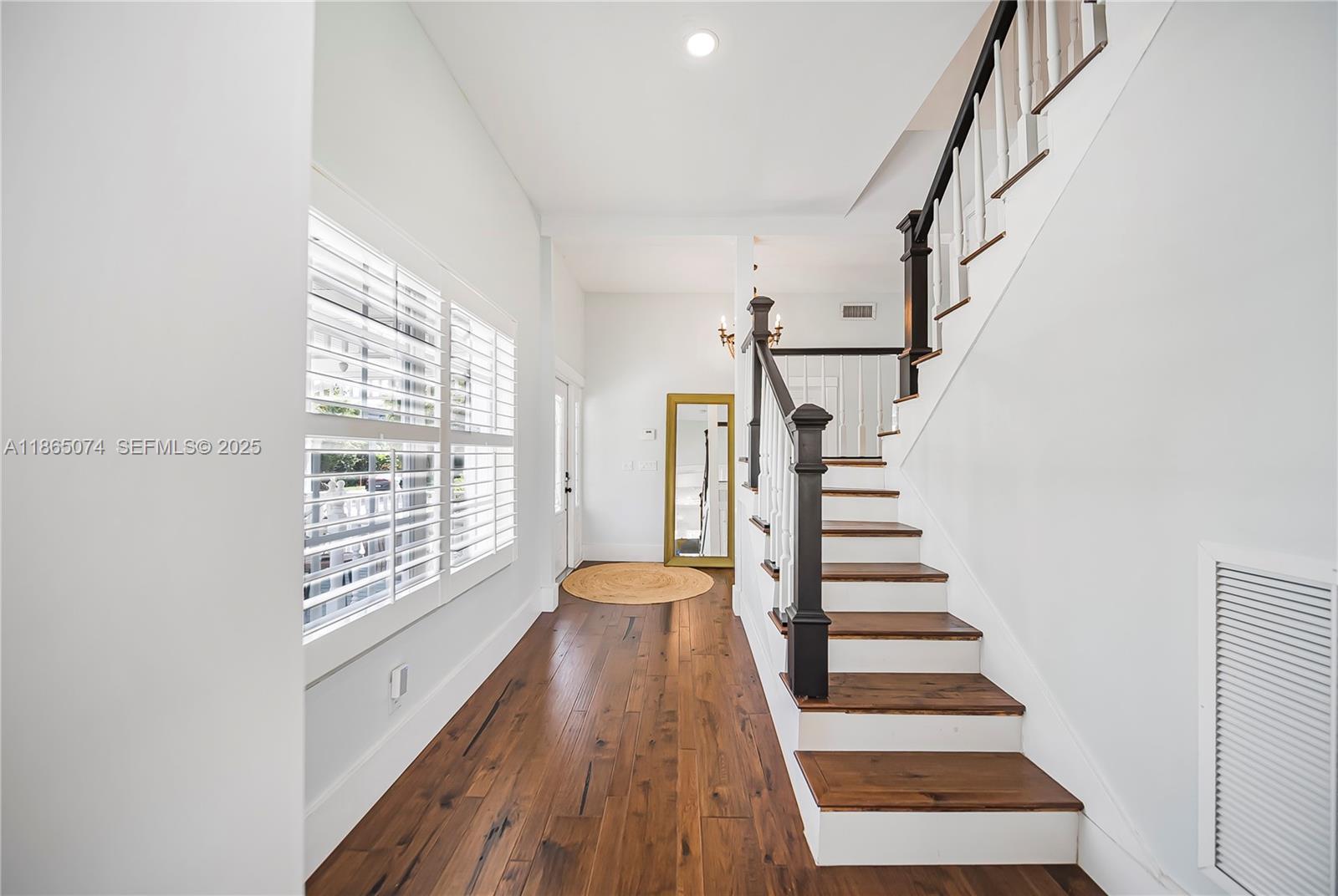 1020 Lands End Way Jupiter, FL 33458 - Photo 39 of 79 a view of staircase with wooden floor and white walls