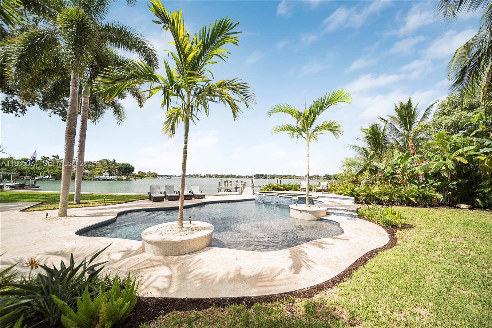 1020 Lands End Way Jupiter, FL 33458 - Photo 9 of 79 a view of a swimming pool with a table and chairs