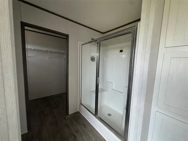 a bathroom with a glass shower door