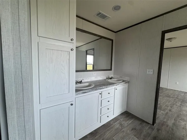 a bathroom with a double vanity sink and mirror