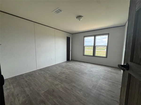 an empty room with windows and closet