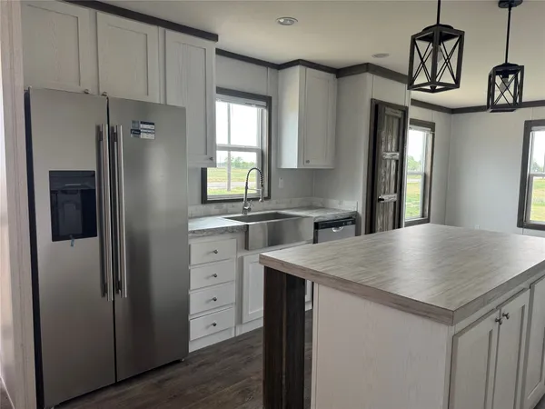 a kitchen with cabinets appliances and a window