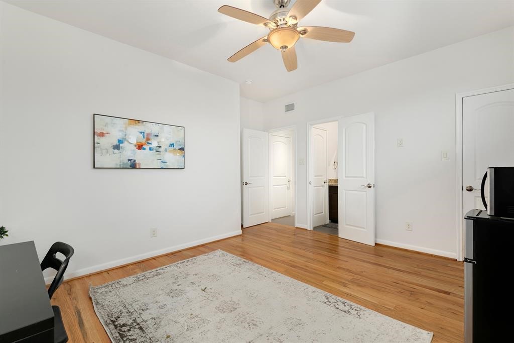 1841 Radcliffe Street Houston, TX 77007 - Photo 15 of 31 a view of a bedroom with a bed and wooden floor