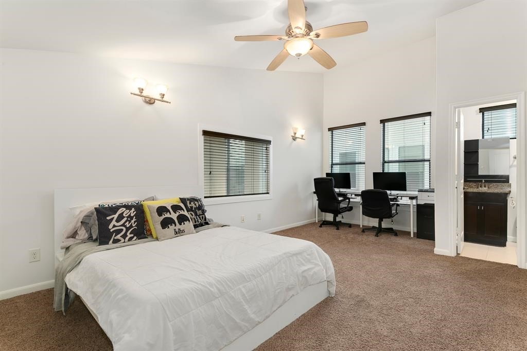 1841 Radcliffe Street Houston, TX 77007 - Photo 22 of 31 a bedroom with a bed and a chandelier