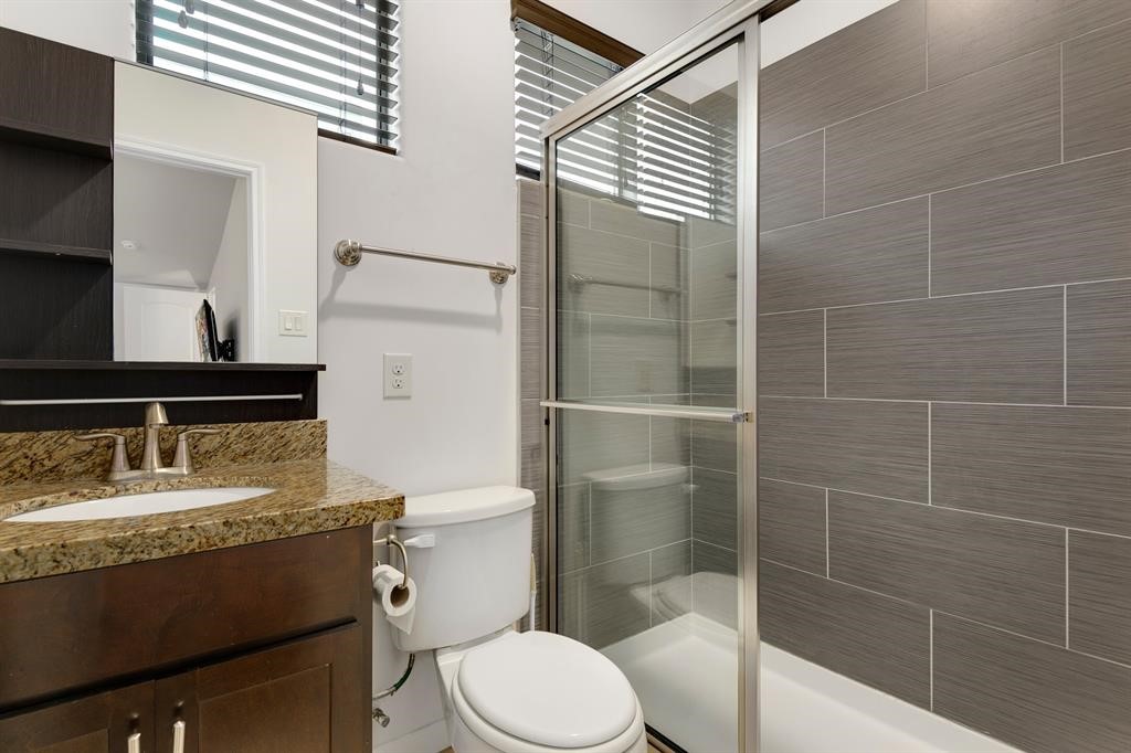 1841 Radcliffe Street Houston, TX 77007 - Photo 24 of 31 a bathroom with a granite countertop sink toilet and shower