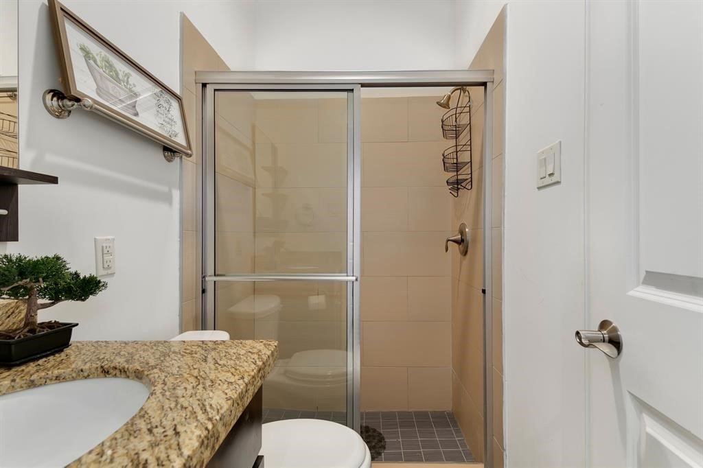 1841 Radcliffe Street Houston, TX 77007 - Photo 25 of 31 a bathroom with a granite countertop sink toilet and shower