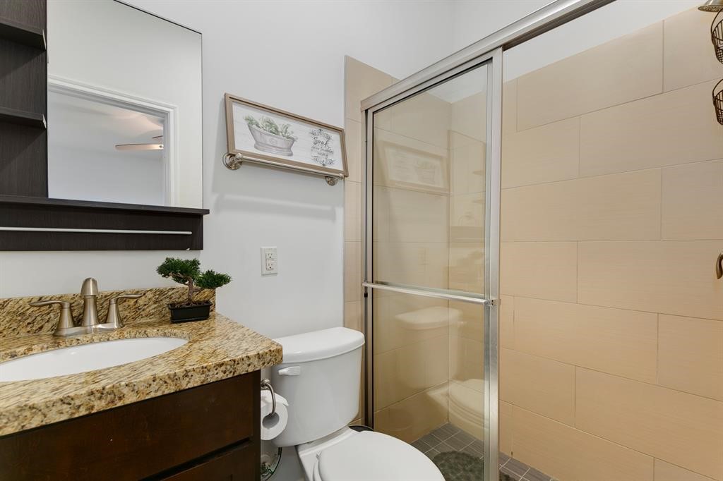 1841 Radcliffe Street Houston, TX 77007 - Photo 26 of 31 a bathroom with a granite countertop sink toilet and shower