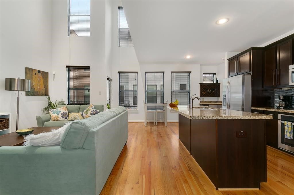 1841 Radcliffe Street Houston, TX 77007 - Photo 3 of 31 a living room with stainless steel appliances kitchen island granite countertop a refrigerator a stove top oven and a sink