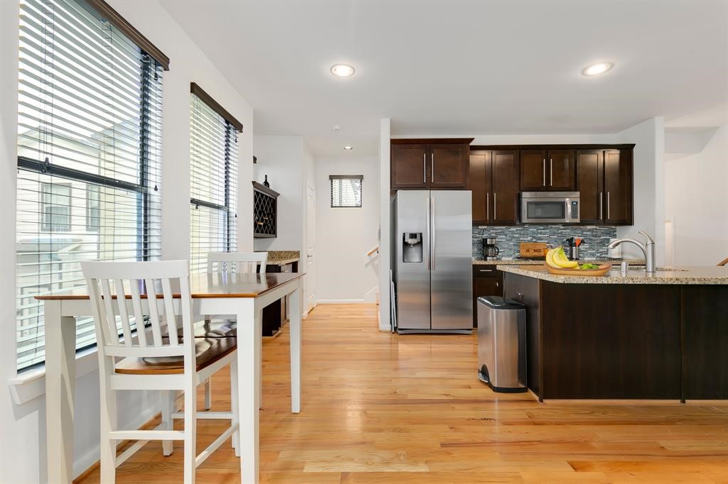 1841 Radcliffe Street Houston, TX 77007 - Photo 8 of 31 a kitchen with stainless steel appliances kitchen island granite countertop a refrigerator and a stove top oven