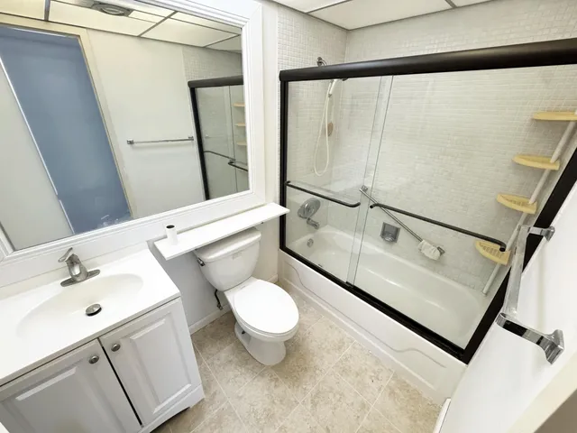 a bathroom with a sink toilet and shower